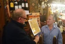 CAMRA Durham chairman Peter Lawson presenting landlord Michael Webster with certificate